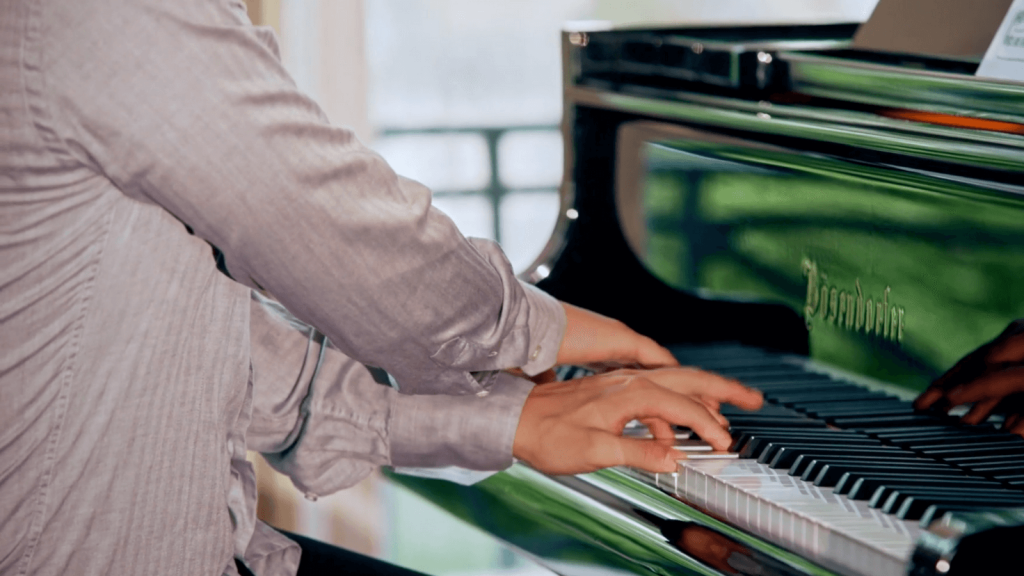 Close-up of pianist George Fu as he plays.