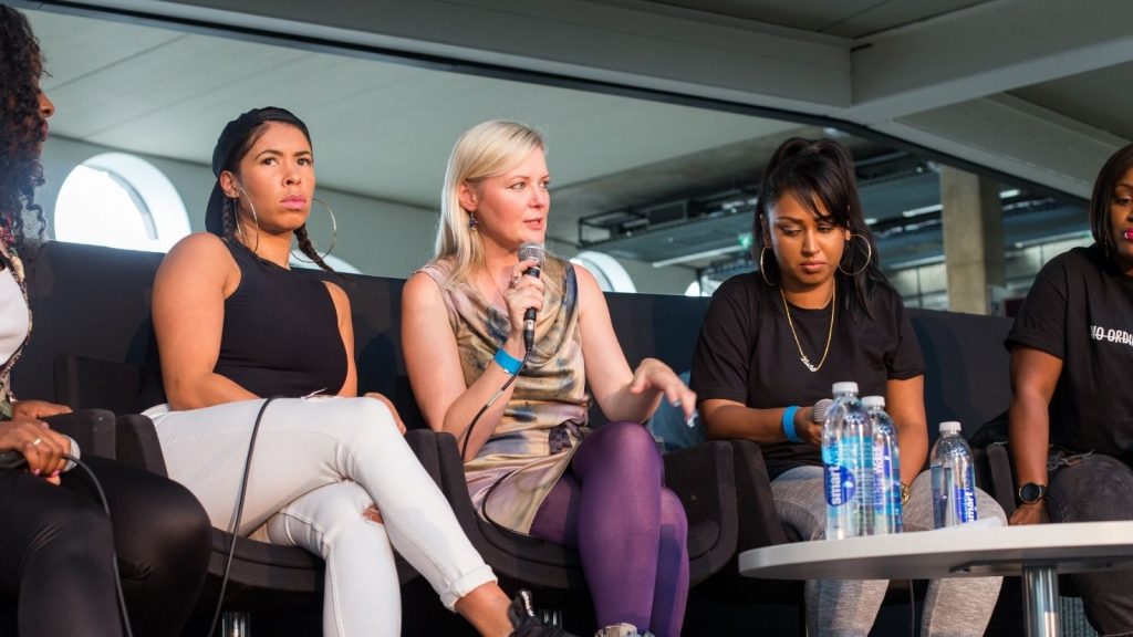 Vick Bain speaks on a panel at an GirlsIRate event.